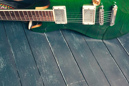 Electric guitar body and neck detail on wooden background