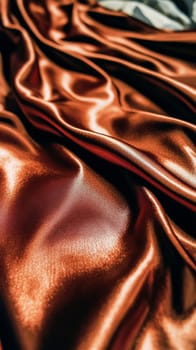 Golden silk fabric flowing in soft folds, creating an elegant and luxurious background. The smooth texture and rich color evoke a sense of opulence and sophistication