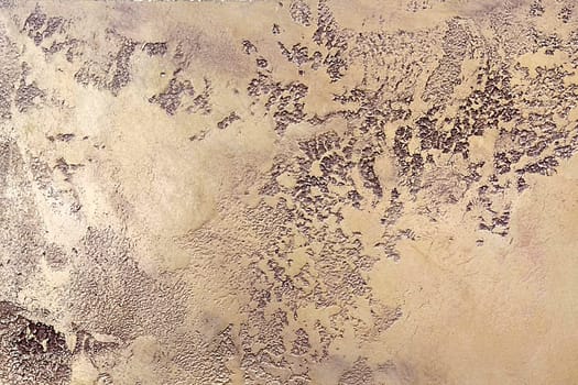 Beige texture of decorative plaster Travertine close-up