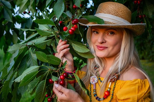 A blonde woman holds ripe cherries beneath a lush cherry tree, branches heavy with fruit. Dressed in a mustard dress, she smiles warmly on a sunny spring day, with a woven basket on her hand.