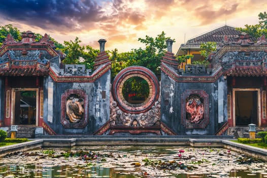 Beautiful Ancient Asian gate to the Buddhist pagoda in Hoi An old town in Vietnam in Asia at sunrise in summer