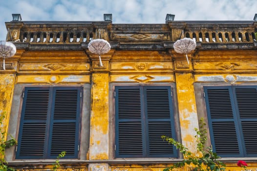 historical facade of an ancient Asian yellow house in the old town in Hoi An in Vietnam in Asia
