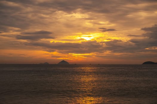 sea at sunset in summer on the background of an orange sky with islands