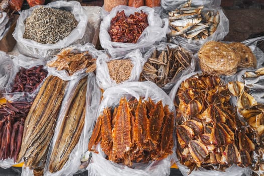 Assortment of dried fish and seafood on the counter at a street market in Vietnam in Asia