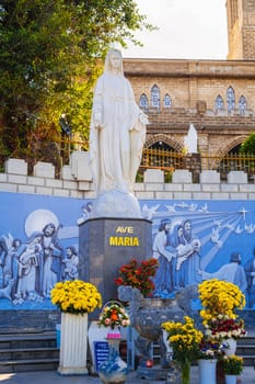 Statue of Saint Maria in the square of Nha Trang Cathedral or Stone Church or Christ the King Cathedral in Asia. Nha Trang, Vietnam - August 22, 2024