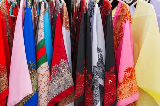 Traditional Asian multicolored silk dresses on the market in Asia in Vietnam