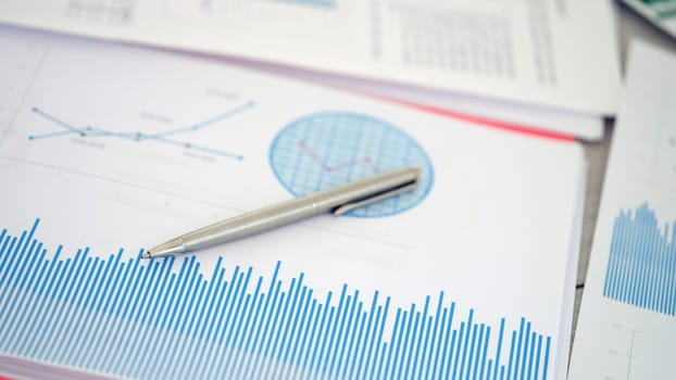 Utilizing graphs and various statistics on financial documents alongside a pen aids in comprehensive analysis