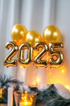 Golden balloons forming number 2025 are hanging on a white wall with fairy lights for new year's eve celebration