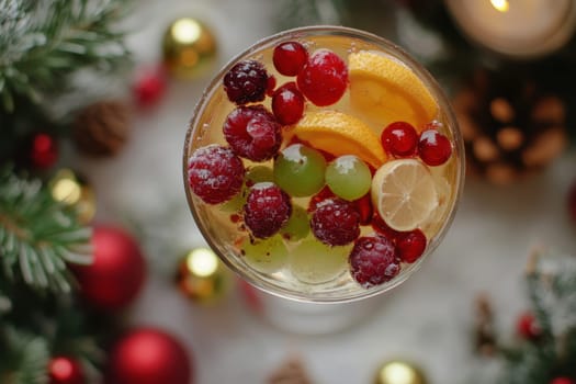 a clear cocktail glass of winter berries and fruits ..
