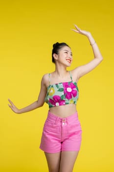 Happy young woman dancing in studio.