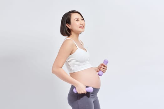 Pregnant female do exercise in sports hall