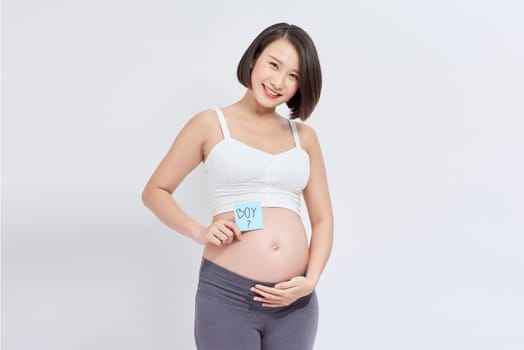 Pregnant woman with stick notes on her belly