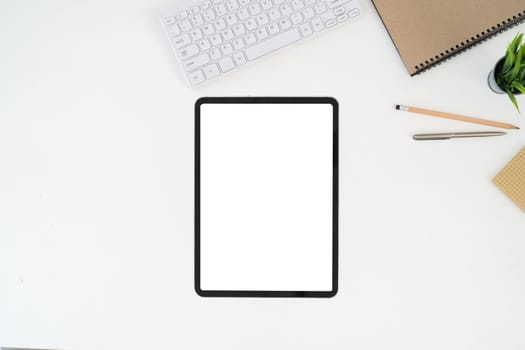 Modern desk workspace with blank copy space mockup with blank screen tablet, coffee cup, technology, headphones with equipment other office top view freelance business concept for social media.