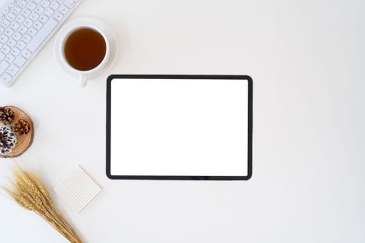 Modern desk workspace with blank copy space mockup with blank screen tablet, coffee cup, technology, headphones with equipment other office top view freelance business concept for social media.