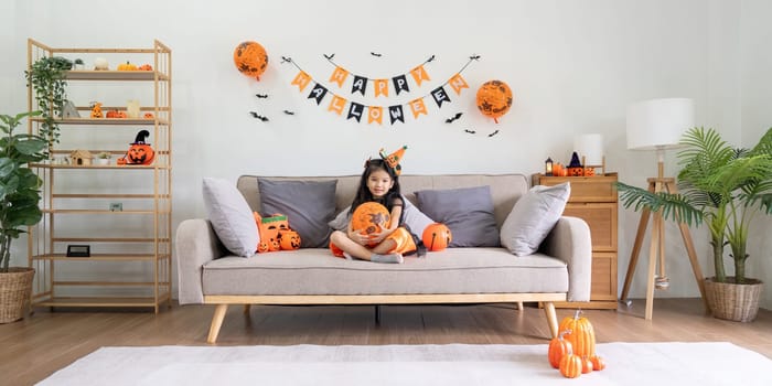 Cute little child girl with balloon. Happy family preparing for Halloween.