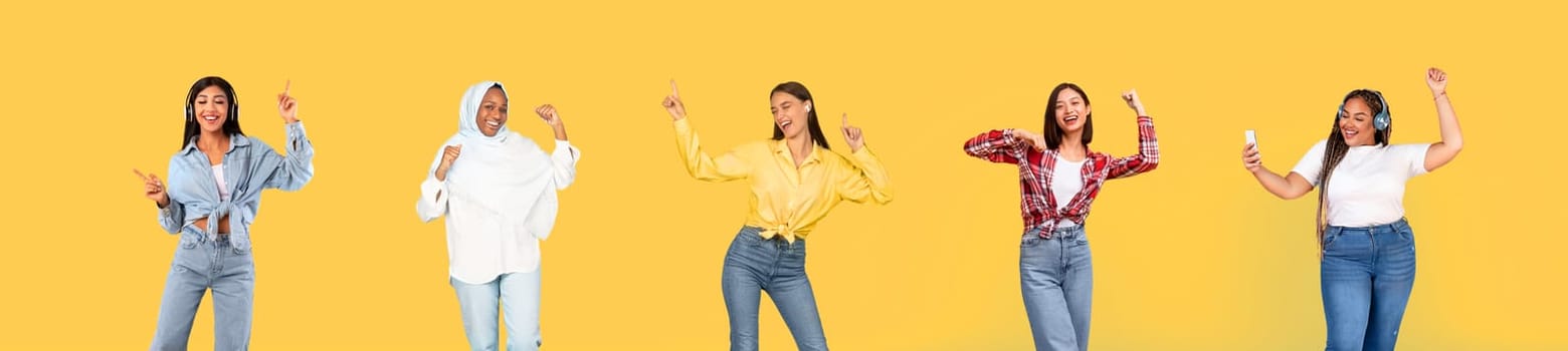 Cheerful international millennial women in wireless headphones dance, have fun, enjoy fun, entertainment, free time, isolated on yellow studio background, panorama. Lifestyle, ad and offer
