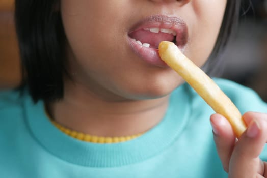 child eating french fries close up ,