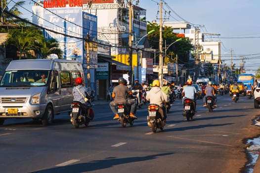 Motorbike traffic on the road in a city in Asia in the summer in day. Nha Trang, Vietnam - August 22, 2024