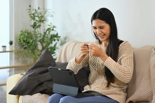 Upset woman destroying her credit card. Financial management and debt reduction concept.