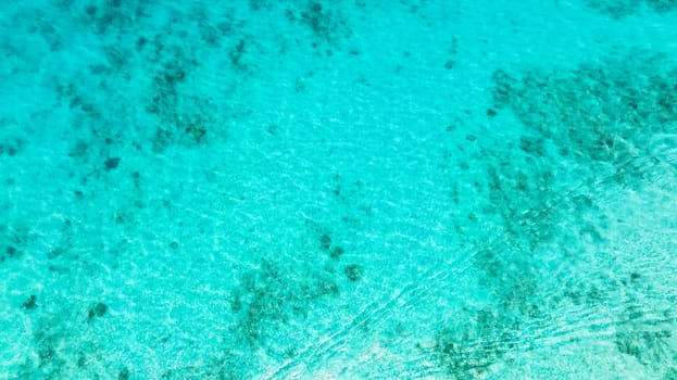 Top view transparent turquoise ocean water surface. Sea water surface in lagoon.