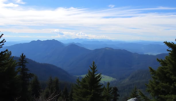 A breathtaking panoramic view of a majestic mountain range under a bright blue sky with wispy clouds. The foreground features lush evergreen trees, adding a sense of depth and scale to the scene. The mountains stretch out into the distance, their peaks disappearing into the haze. This image evokes a feeling of tranquility and vastness, perfect for nature-themed projects, travel brochures, or as a backdrop for your designs.
