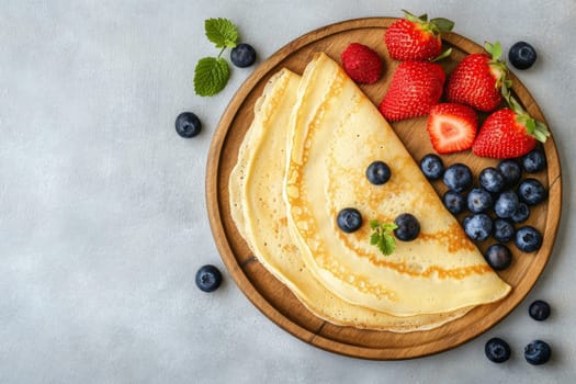 Hot delicious pancakes decorated with blueberries and strawberries. High quality photo