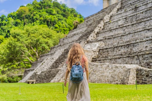 Female tourist exploring the ancient pyramids of Palenque, Mexico, surrounded by dense jungle. Cultural heritage and adventure travel concept.