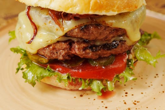 Juicy burger stacked with fresh ingredients showcases vibrant colors in a warm restaurant setting