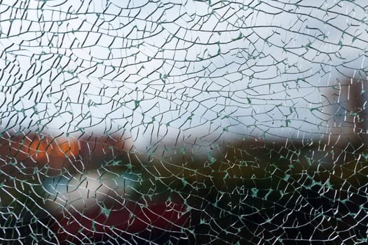 Delicate shards of broken glass create a mesmerizing texture, softening the view of a colorful