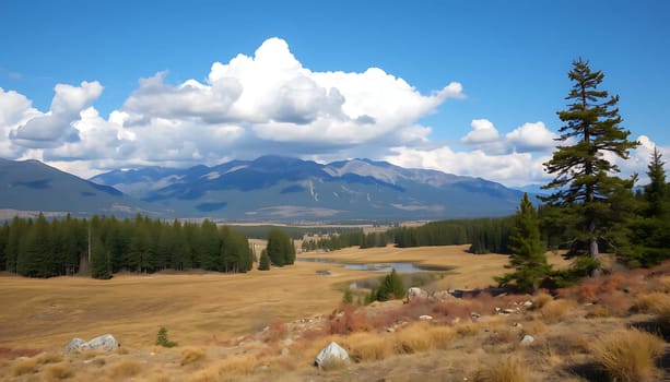 A picturesque landscape featuring a vast meadow with dry grass, a small lake in the distance, and a towering pine tree in the foreground. The majestic mountain range in the background is framed by fluffy white clouds against a bright blue sky. This image evokes a sense of tranquility and beauty, ideal for projects related to nature, tranquility, or travel.