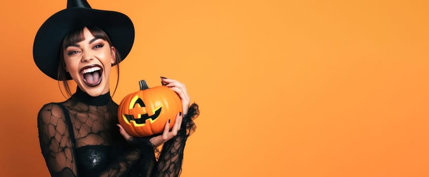 Banner of Cheerful young woman in a black witch hat smiling with a jack-o-lantern on an orange background.