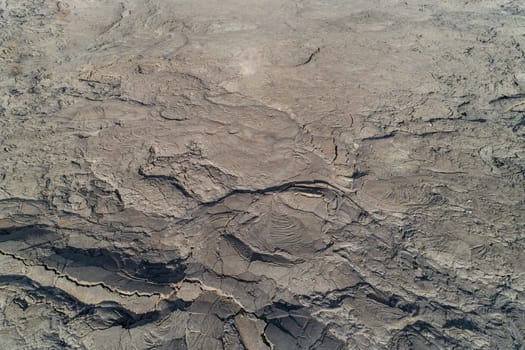 A detailed photo showcasing the rugged texture of dry, cracked earth in a desert environment, highlighting arid and barren natural landscapes at jordan craters
