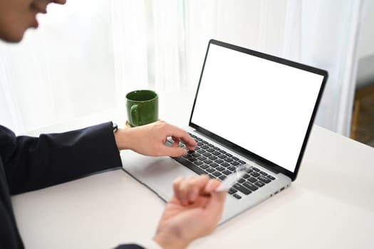 Close up shot businessman making a purchase or payment with credit card online.