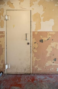 A vintage door with peeling paint, showing aged and rustic charm. Perfect for themes of decay, history, and urban exploration.