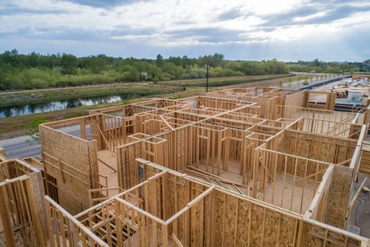 Aerial view of a house under construction where the roof is in progress.