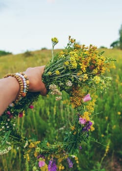 Woman in a meadow with medicinal herbs. Selective focus. Nature.