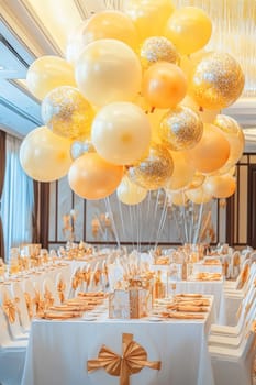 Bunch of yellow balloons floating over banquet table decorated for new year eve party 2025