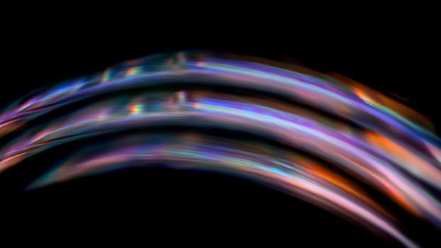 Three abstract colorful wavy lines are flowing on black background and creating an abstract art with a sense of movement
