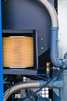Replacing air filter cartridge in industrial compressor unit during maintenance