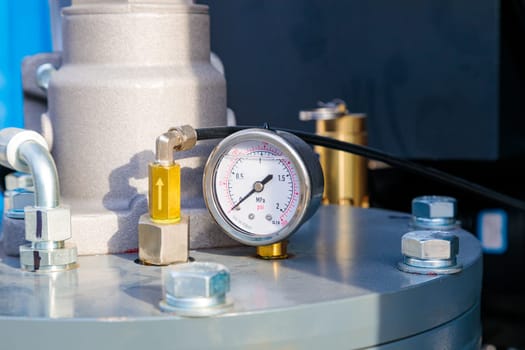 Close-up of pressure gauge indicating pressure in industrial pipeline system, emphasizing industrial processes and monitoring