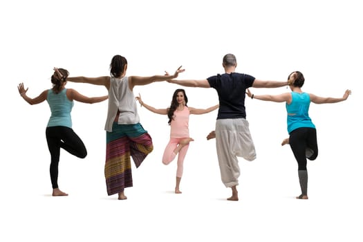 Group of women and their male trainer in sportswear doing yoga staying in a circle view against brick wall