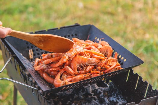 Grilling shrimp on a barbecue. Selective focus. food.