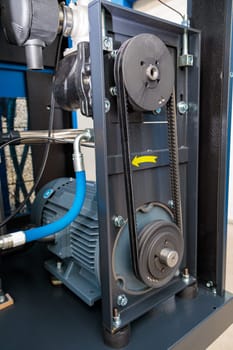 Close-up of a belt drive system, showcasing the rotation and power transmission within industrial machinery