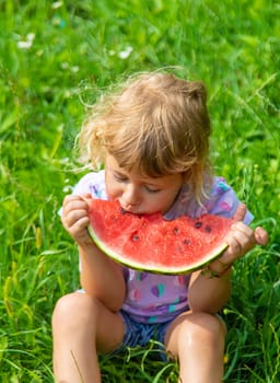 Child eats watermelon in summer. Selective focus. Kid.