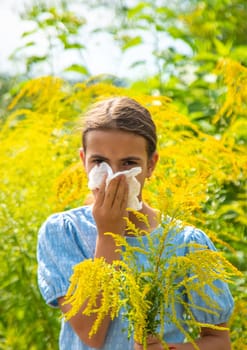 Child in ragweed flowers allergy. Selective focus. Kid.