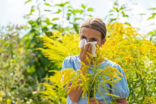 Child in ragweed flowers allergy. Selective focus. Kid.