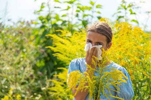 Child in ragweed flowers allergy. Selective focus. Kid.