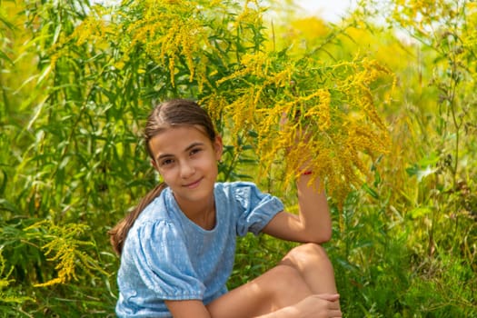 Child in ragweed flowers allergy. Selective focus. Kid.
