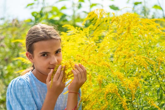 Child in ragweed flowers allergy. Selective focus. Kid.