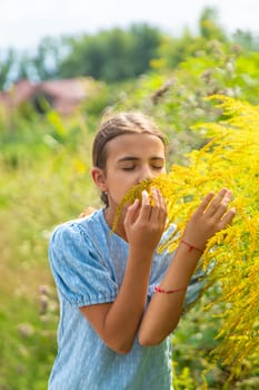 Child in ragweed flowers allergy. Selective focus. Kid.